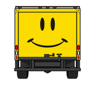 Yellow Friendship Builders truck rear with smiling face and tires